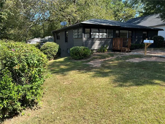 a backyard of a house with barbeque oven and outdoor seating