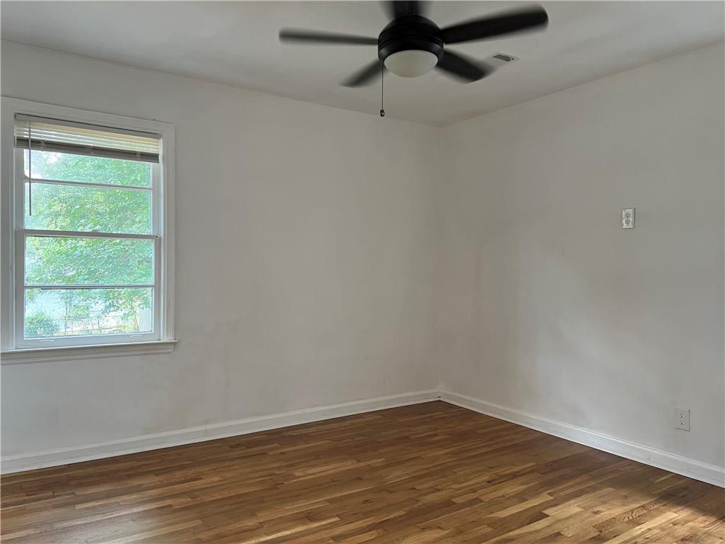1215 Westview Drive Southwest, Unit A Atlanta, GA 30310 - Photo 17 of 25 a view of an empty room with wooden floor and a window