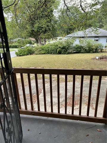 a view of staircase with wooden floor and chair