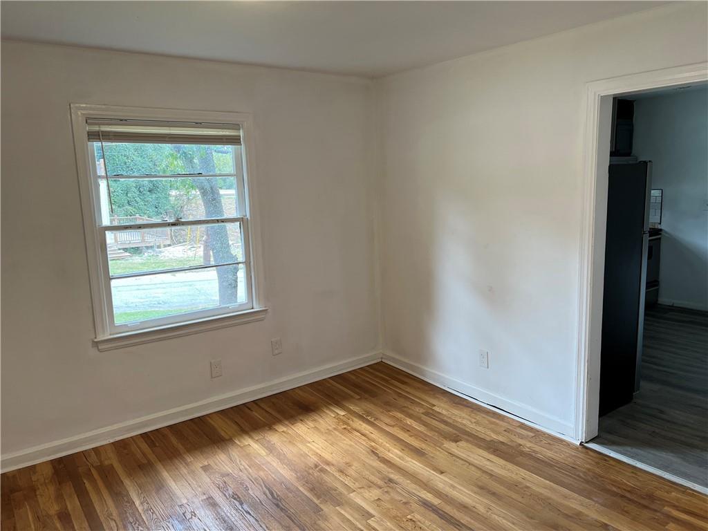 1215 Westview Drive Southwest, Unit A Atlanta, GA 30310 - Photo 9 of 25 an empty room with wooden floor and windows