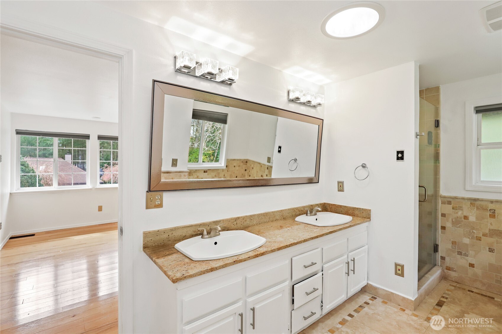1063 Southwest Depot Court Port Orchard, WA 98367 - Photo 15 of 40 a bathroom with a granite countertop sink and a mirror