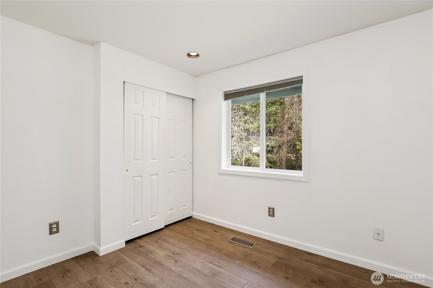 1063 Southwest Depot Court Port Orchard, WA 98367 - Photo 20 of 40 a view of an empty room with wooden floor and a window
