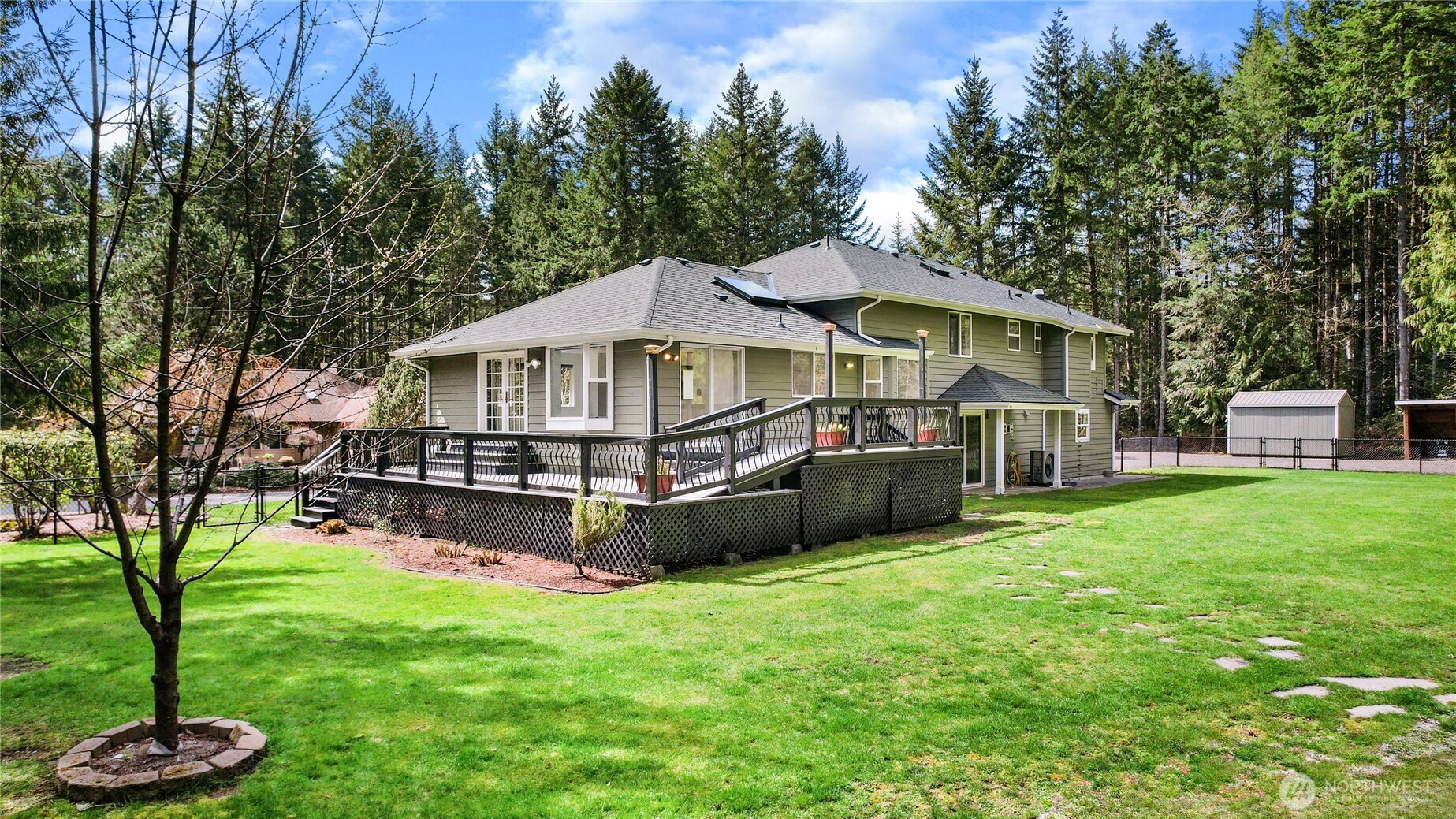 1063 Southwest Depot Court Port Orchard, WA 98367 - Photo 35 of 40 a view of a house with a yard deck and a large tree