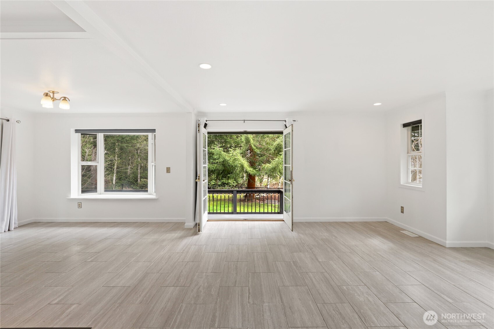 1063 Southwest Depot Court Port Orchard, WA 98367 - Photo 7 of 40 an empty room with wooden floor and windows
