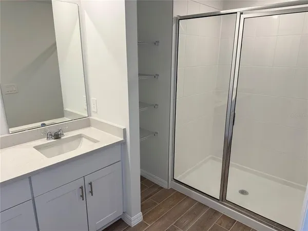 a bathroom with a double vanity sink and a mirror