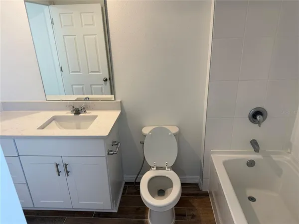 a bathroom with a sink a toilet and bathtub