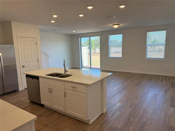 a kitchen with sink and cabinets