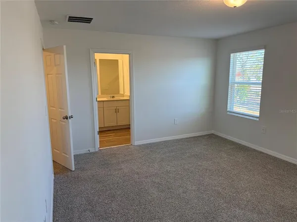 an empty room with windows and closet