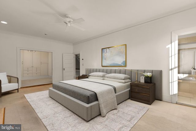 a bedroom with a large bed and a chandelier