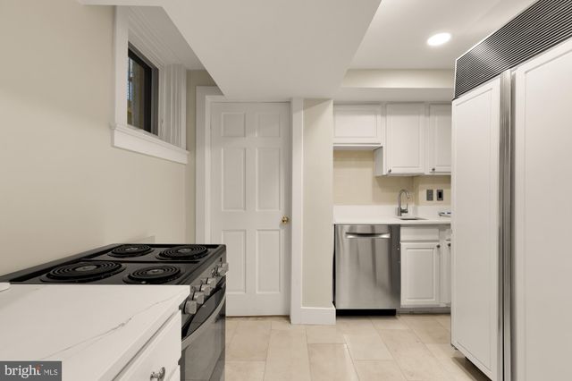 a kitchen with a stove and a refrigerator