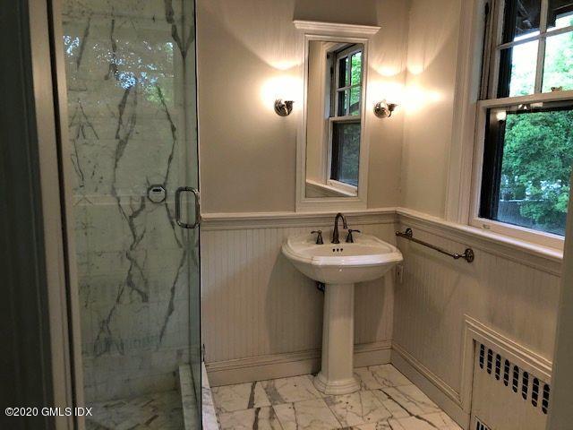 5 Brookridge Drive Greenwich, CT 06830 - Photo 14 of 17 a bathroom with a sink mirror and shower