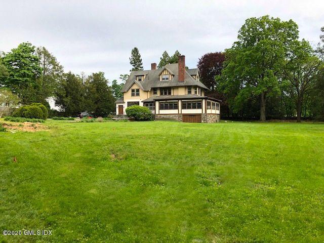 5 Brookridge Drive Greenwich, CT 06830 - Photo 2 of 17 a view of a white house with a big yard and large trees