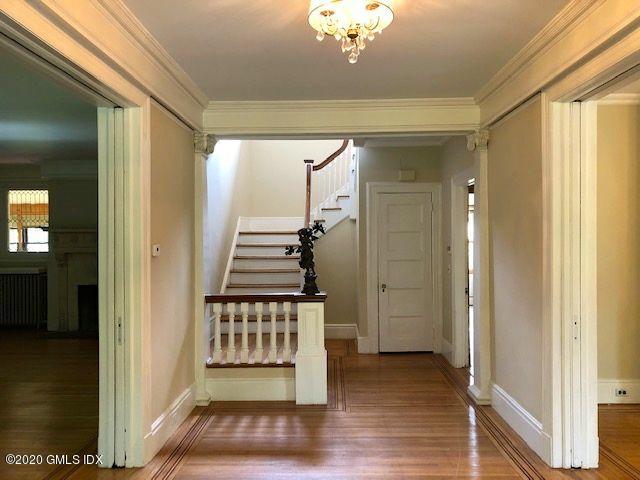 5 Brookridge Drive Greenwich, CT 06830 - Photo 5 of 17 a view of a hallway with wooden floor and staircase