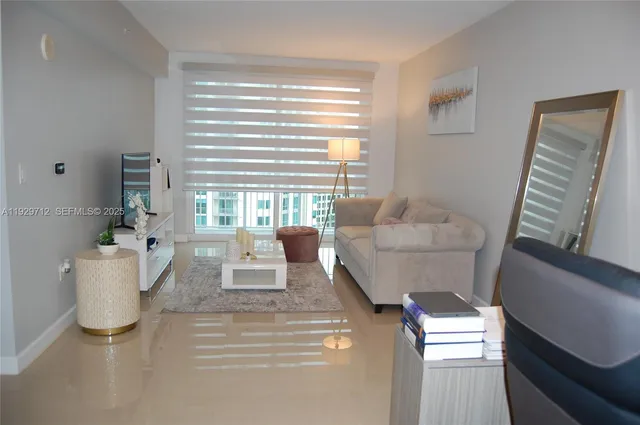 a living room with furniture and a large window