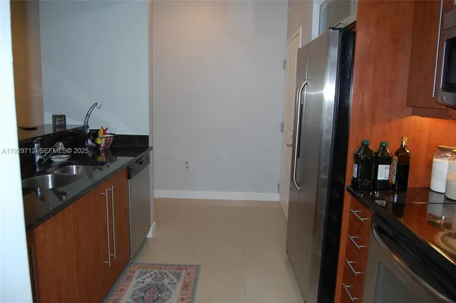 a kitchen with a sink and a refrigerator