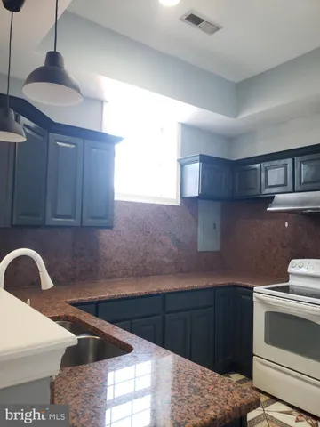 a kitchen with a sink and a stove top oven