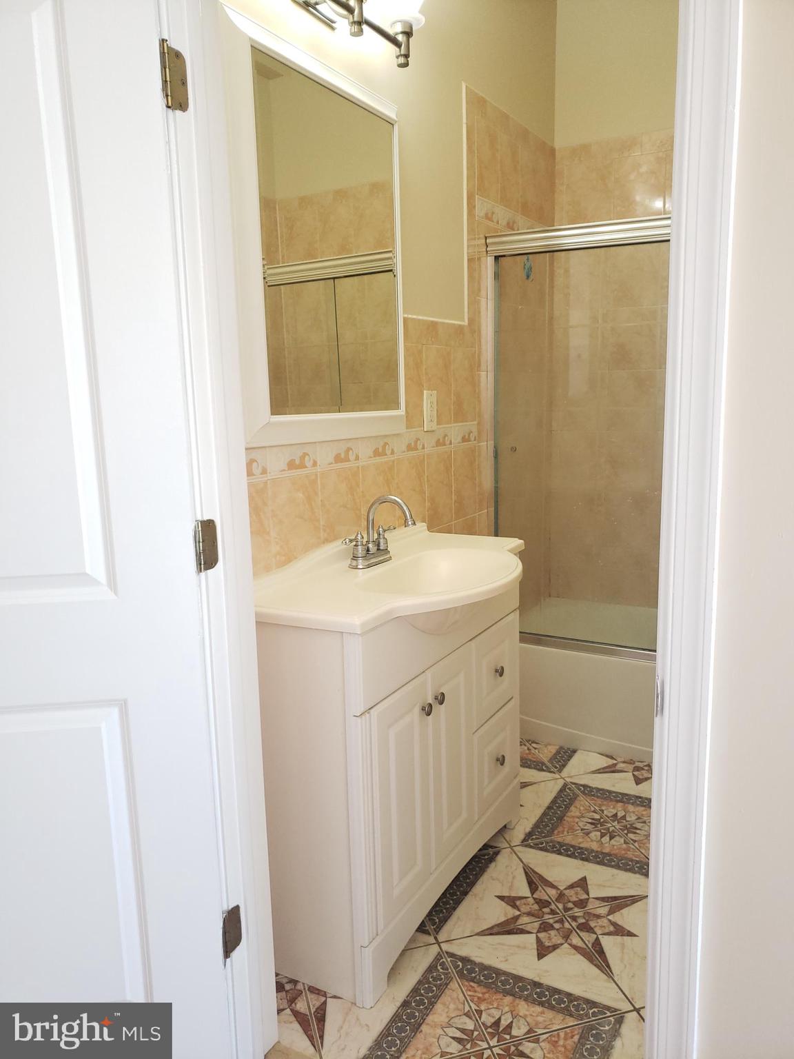 1119 South 18th Street Philadelphia, PA 19146 - Photo 7 of 9 a bathroom with a sink and a mirror