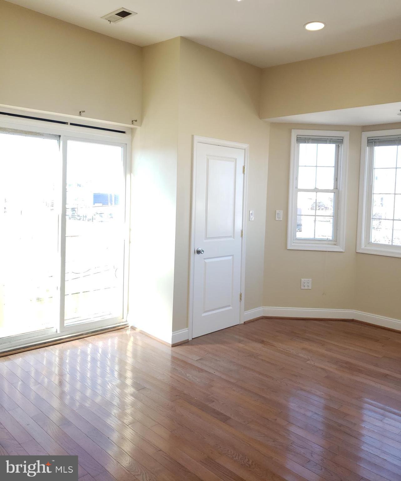 1119 South 18th Street Philadelphia, PA 19146 - Photo 8 of 9 an empty room with wooden floor and windows