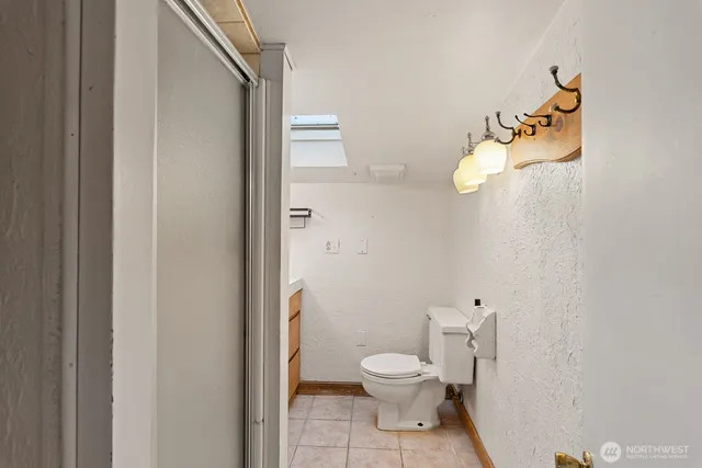 a bathroom with a toilet a sink and shower