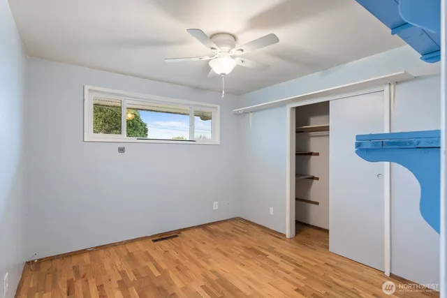 a view of a room with a ceiling fan a window and a ceiling fan