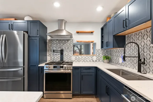 a kitchen with stainless steel appliances a sink cabinets and a refrigerator