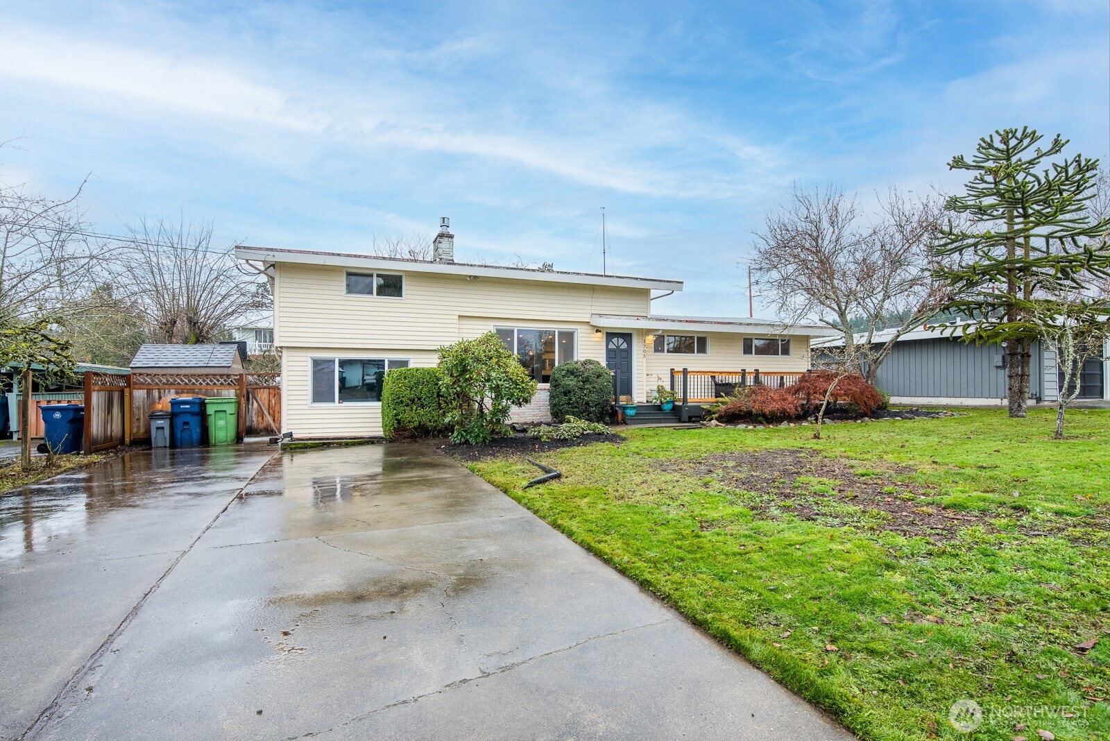 1705 36th Street Anacortes, WA 98221 - Photo 23 of 39 a view of a big house with a big yard and potted plants