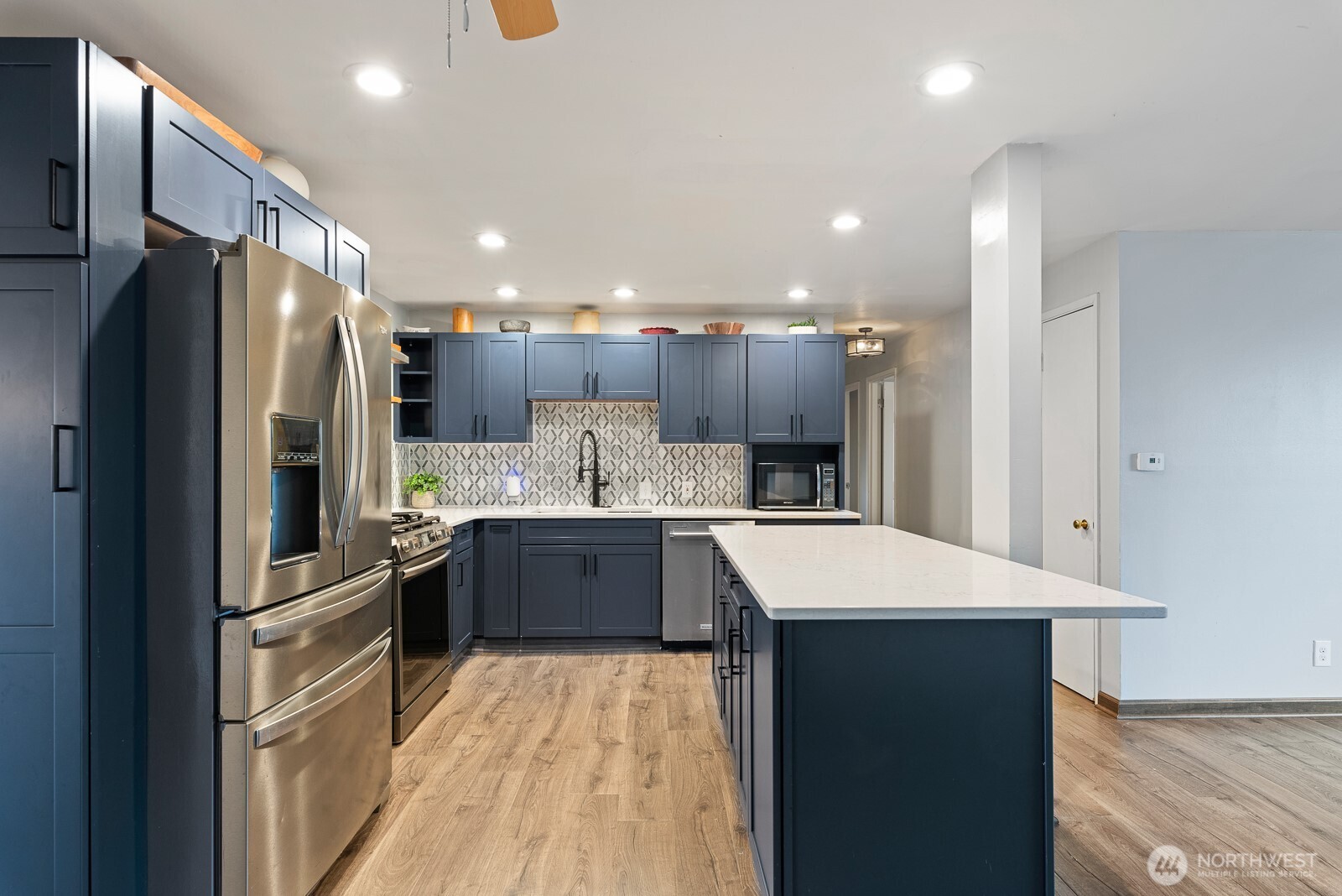 1705 36th Street Anacortes, WA 98221 - Photo 3 of 39 a kitchen with kitchen island stainless steel appliances sink refrigerator and microwave