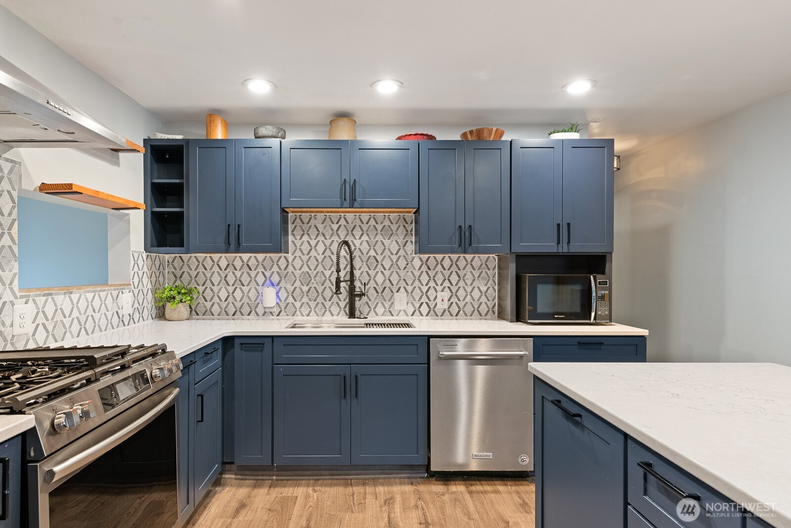 1705 36th Street Anacortes, WA 98221 - Photo 4 of 39 a kitchen with stainless steel appliances granite countertop wooden cabinets and a stove top oven