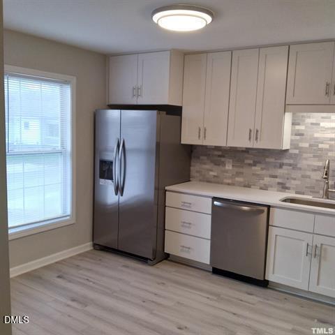 1015 Holmes Street Raleigh, NC 27601 - Photo 5 of 12 a kitchen with granite countertop white cabinets and stainless steel appliances