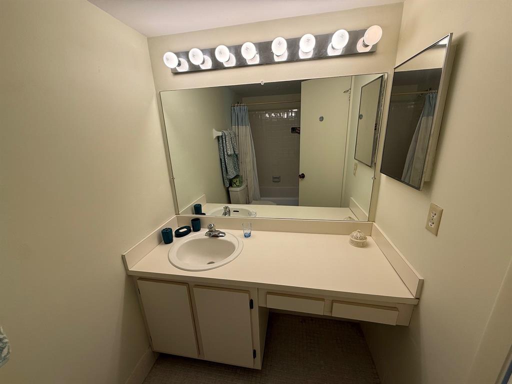 8405 Northwest 61st Street, Unit D315 Tamarac, FL 33321 - Photo 14 of 26 a bathroom with a sink and a mirror