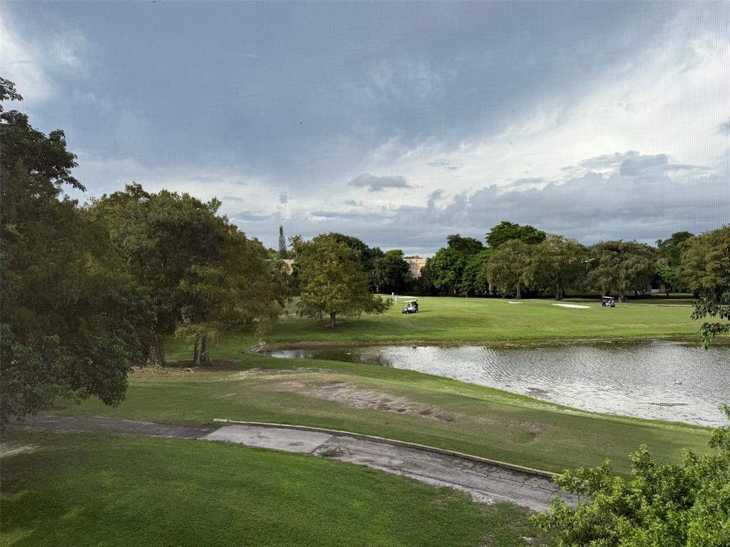 8405 Northwest 61st Street, Unit D315 Tamarac, FL 33321 - Photo 19 of 26 a view of a lake with a big yard