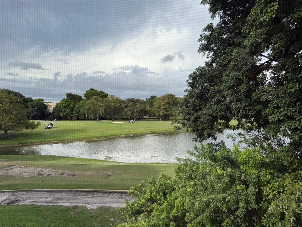 8405 Northwest 61st Street, Unit D315 Tamarac, FL 33321 - Photo 20 of 26 a view of a lake with a big yard
