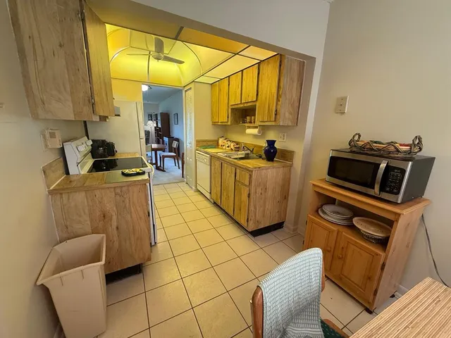 a kitchen with a sink appliances and cabinets