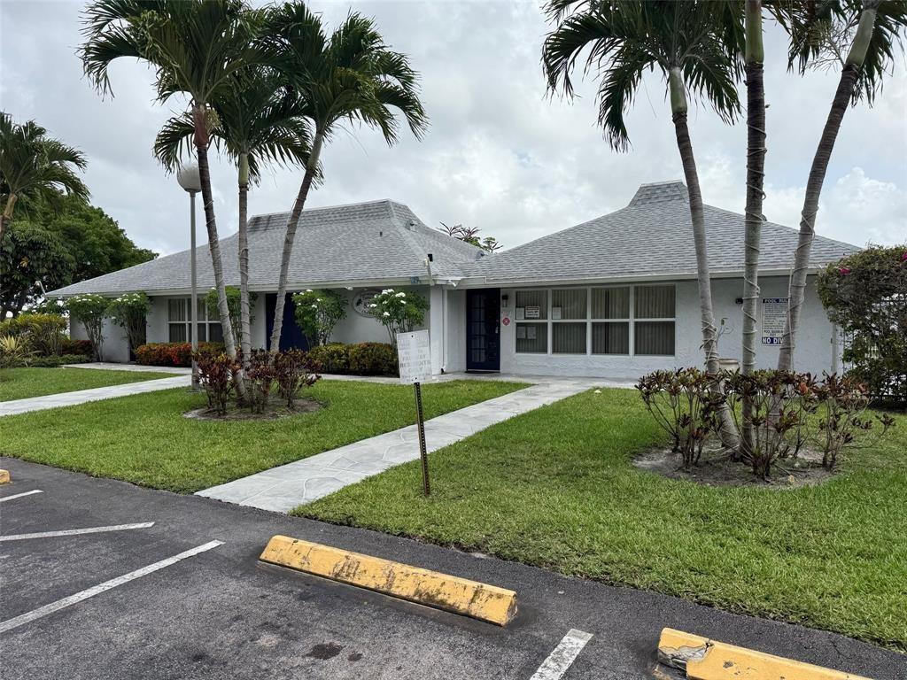 8405 Northwest 61st Street, Unit D315 Tamarac, FL 33321 - Photo 22 of 26 front view of a house with a yard