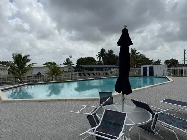an outdoor space with lounge chairs
