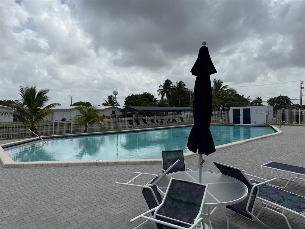 8405 Northwest 61st Street, Unit D315 Tamarac, FL 33321 - Photo 23 of 26 an outdoor space with lounge chairs