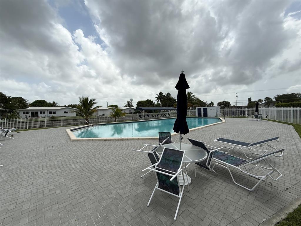 8405 Northwest 61st Street, Unit D315 Tamarac, FL 33321 - Photo 24 of 26 a terrace of a house with outdoor seating