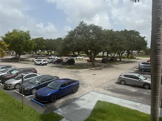 a view of a yard with cars