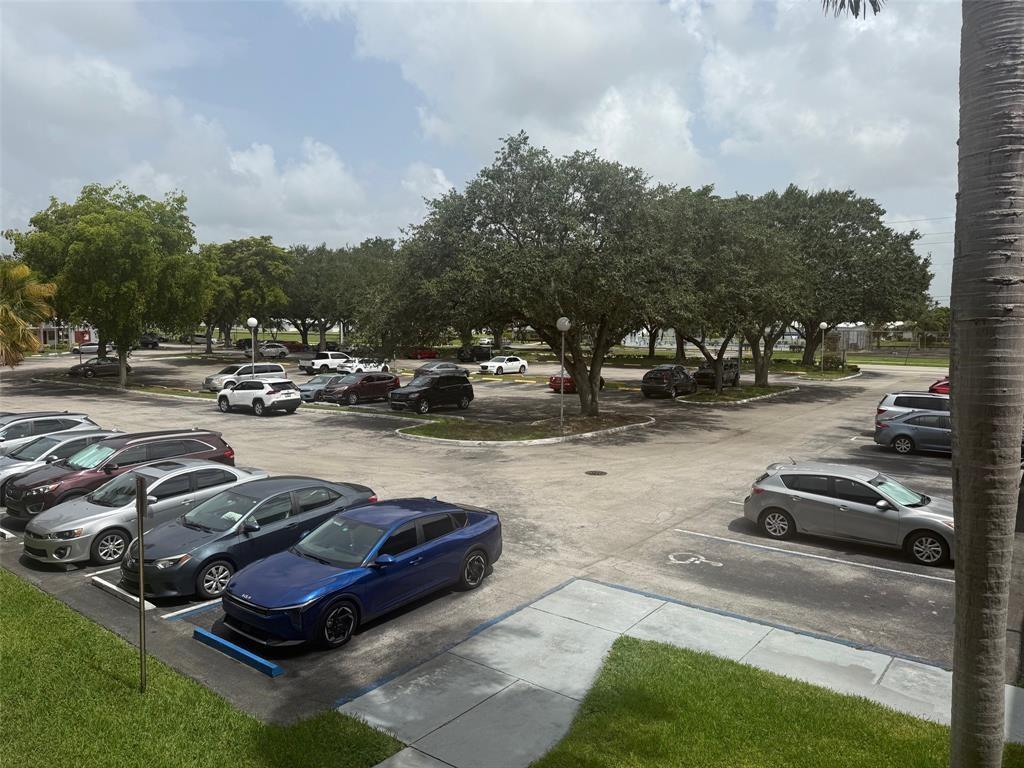 8405 Northwest 61st Street, Unit D315 Tamarac, FL 33321 - Photo 26 of 26 a view of a yard with cars