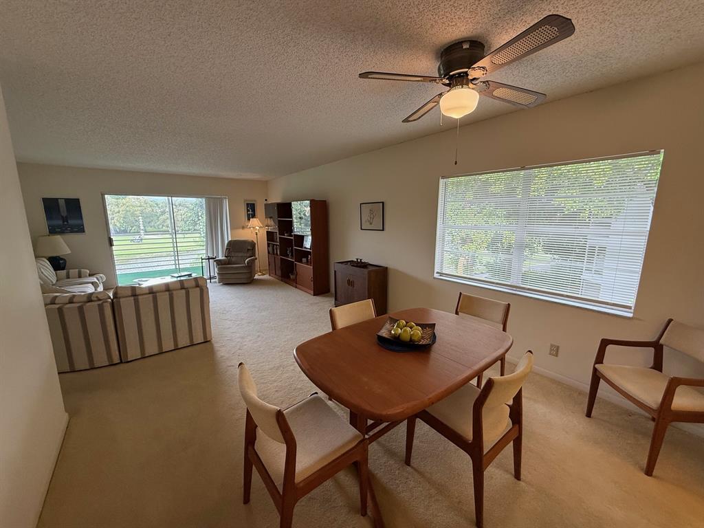 8405 Northwest 61st Street, Unit D315 Tamarac, FL 33321 - Photo 6 of 26 a living room with furniture and a large window