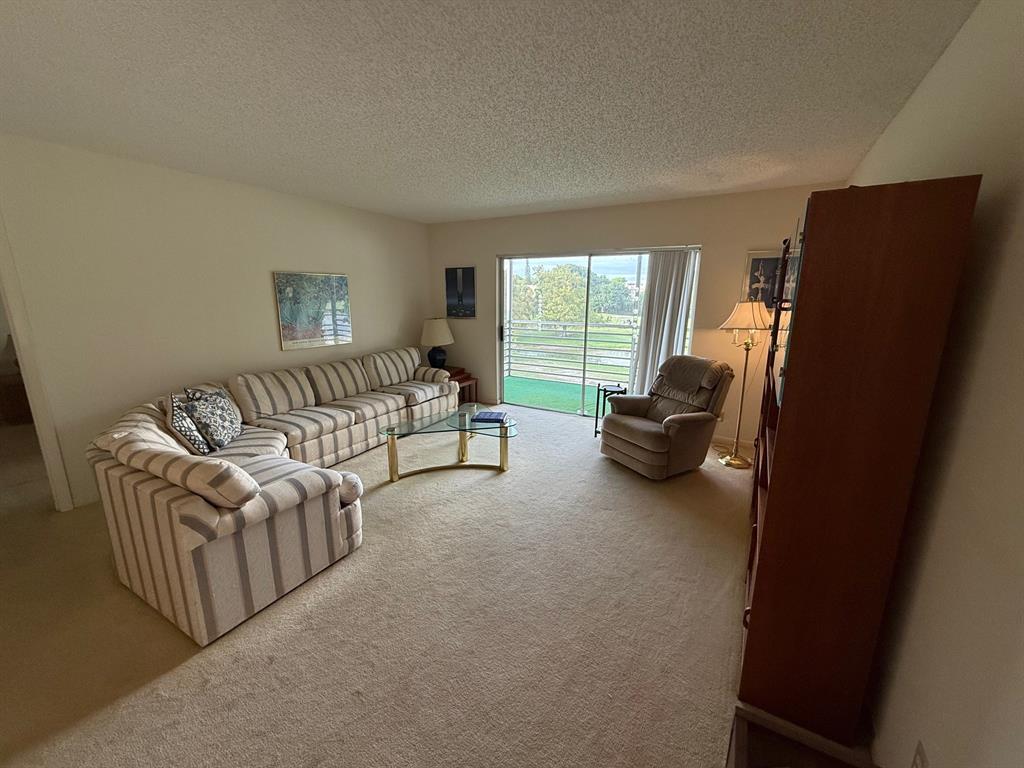 8405 Northwest 61st Street, Unit D315 Tamarac, FL 33321 - Photo 9 of 26 a living room with furniture rug and a window