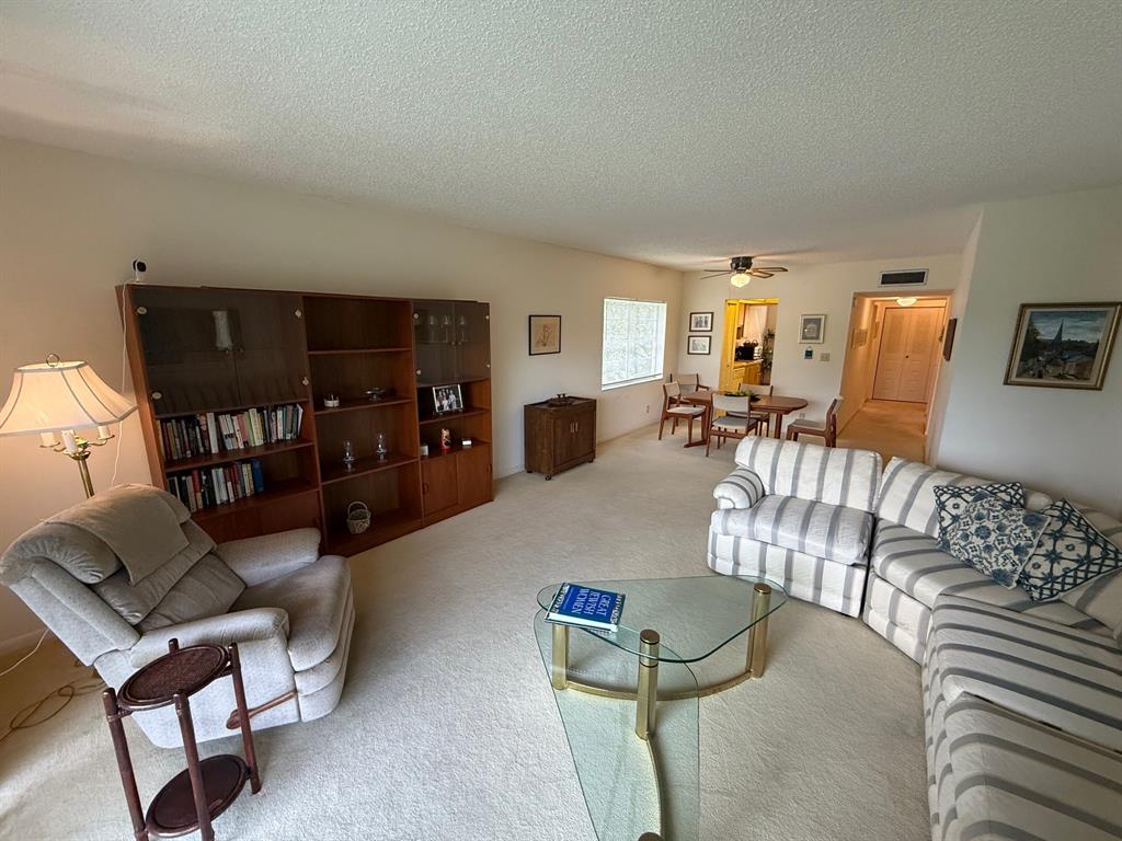 8405 Northwest 61st Street, Unit D315 Tamarac, FL 33321 - Photo 10 of 26 a living room with furniture and a window