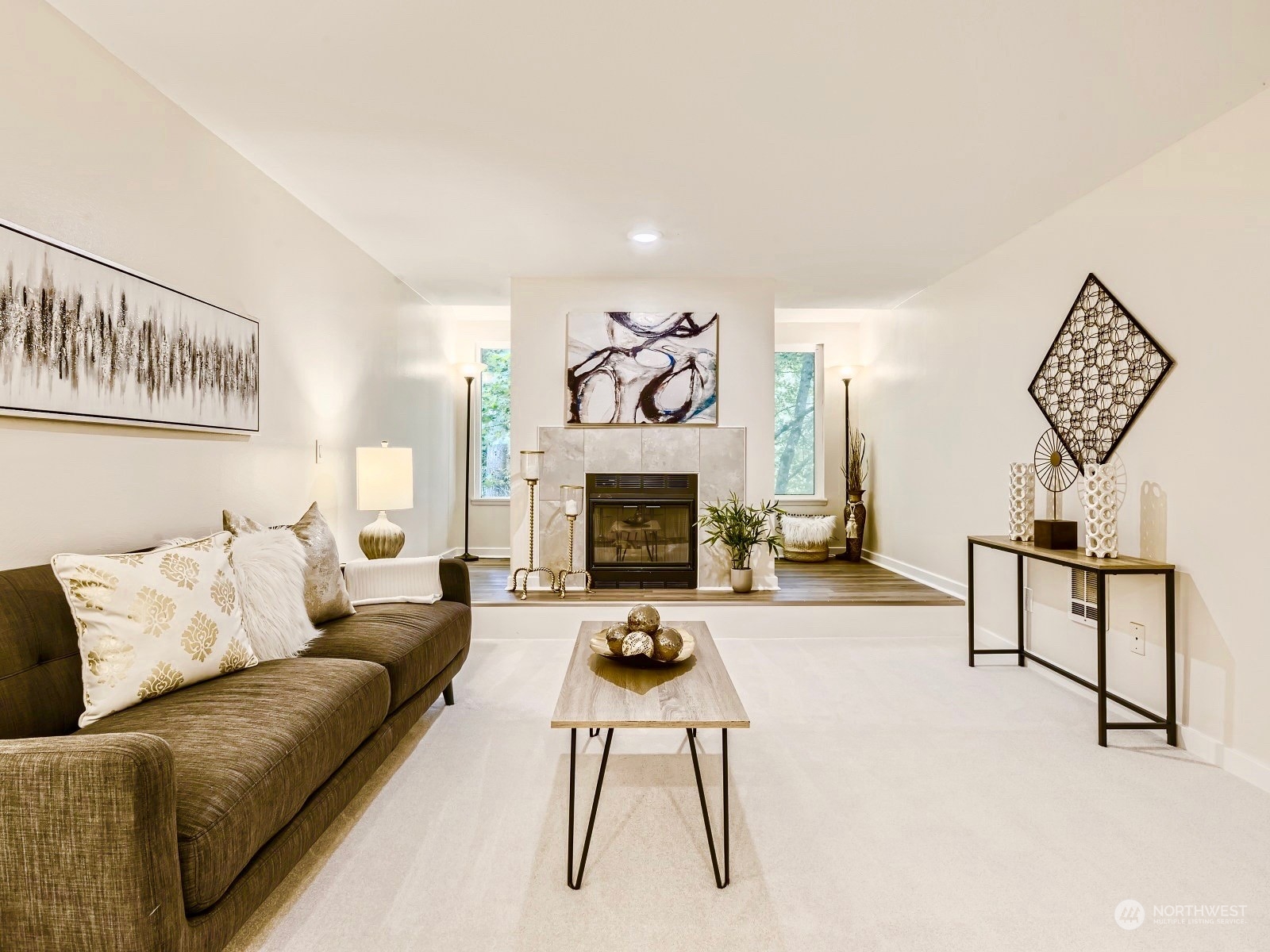 13717 Linden Avenue North, Unit 322 Seattle, WA 98133 - Photo 1 of 22 a living room with furniture a table and a fireplace