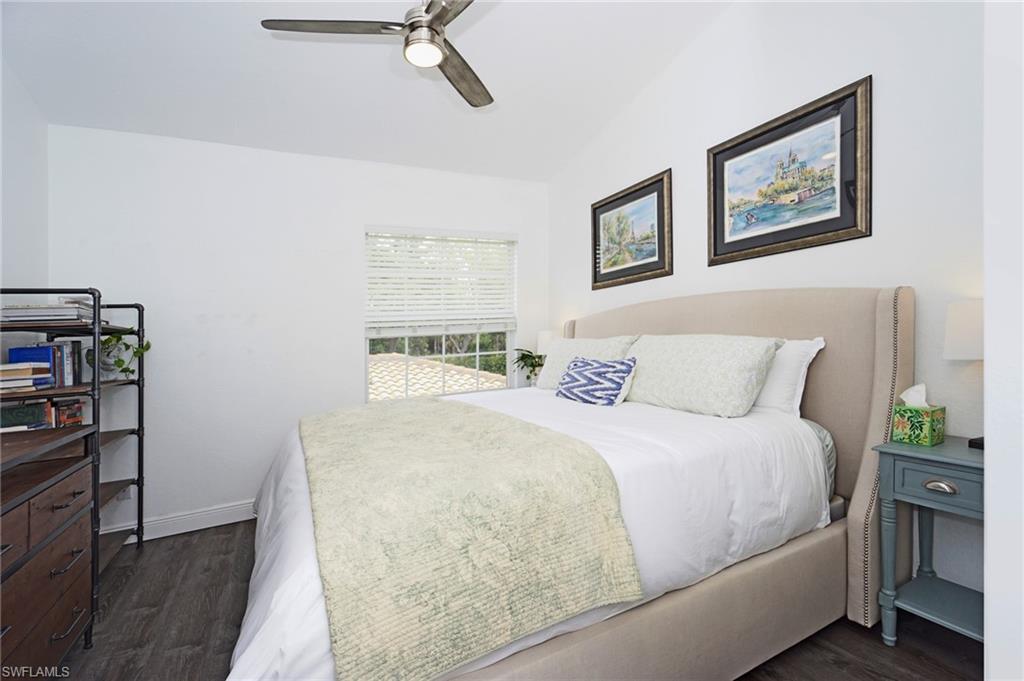 6910 Satinleaf Road North, Unit 204 Naples, FL 34109 - Photo 19 of 31 Bedroom featuring dark wood-style floors, ceiling fan, and baseboards