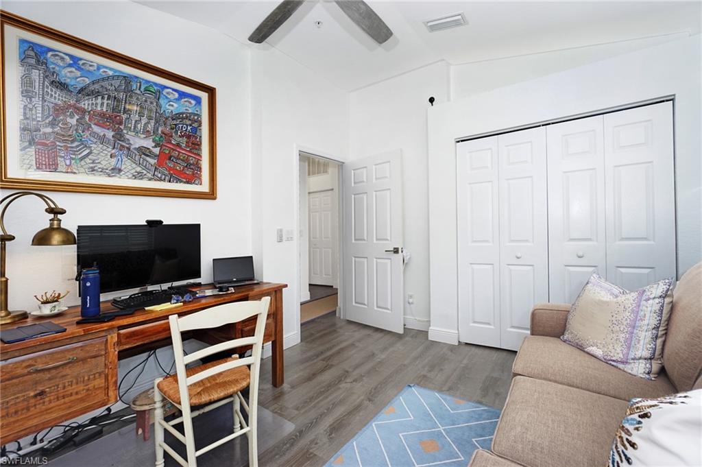 6910 Satinleaf Road North, Unit 204 Naples, FL 34109 - Photo 21 of 31 Home office featuring a ceiling fan, wood finished floors, lofted ceiling, baseboards, and visible vents