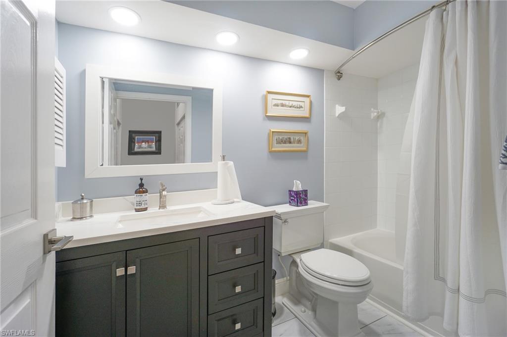 6910 Satinleaf Road North, Unit 204 Naples, FL 34109 - Photo 22 of 31 Full bathroom featuring shower / bath combination with curtain, recessed lighting, toilet, and vanity