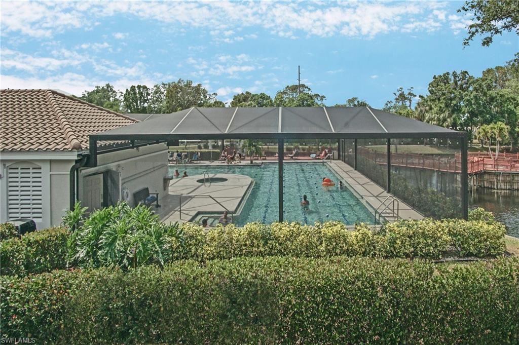 6910 Satinleaf Road North, Unit 204 Naples, FL 34109 - Photo 28 of 31 Community pool featuring a lanai and a patio