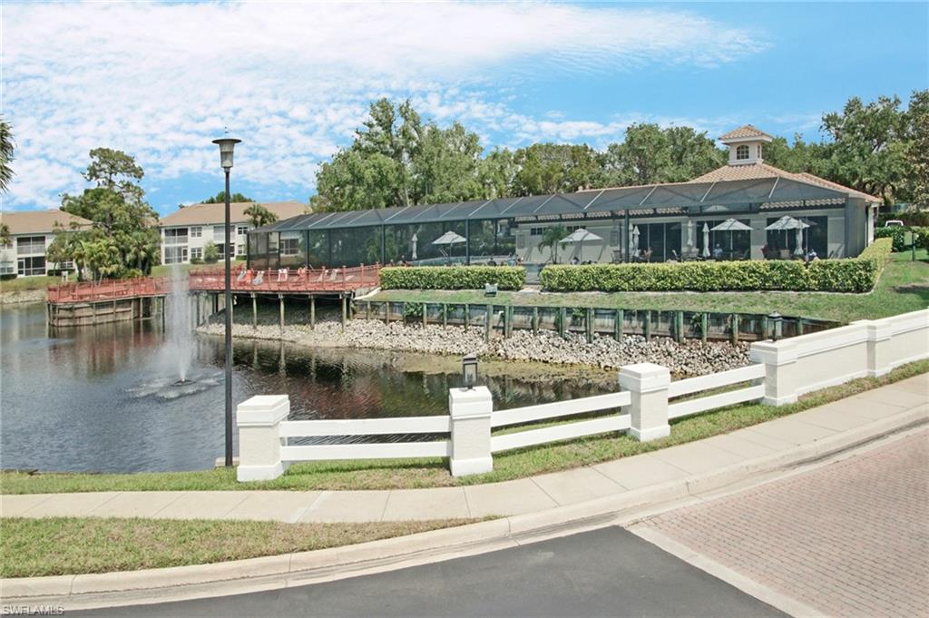 6910 Satinleaf Road North, Unit 204 Naples, FL 34109 - Photo 29 of 31 View of property's community featuring a water view and a residential view