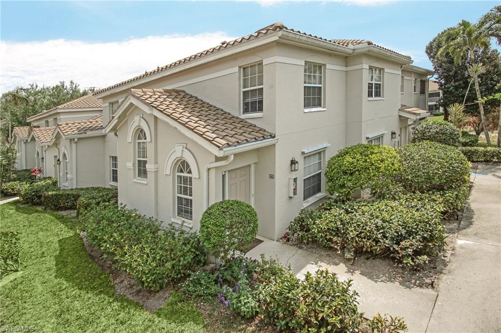 6910 Satinleaf Road North, Unit 204 Naples, FL 34109 - Photo 3 of 31 View of property exterior with stucco siding and a tiled roof