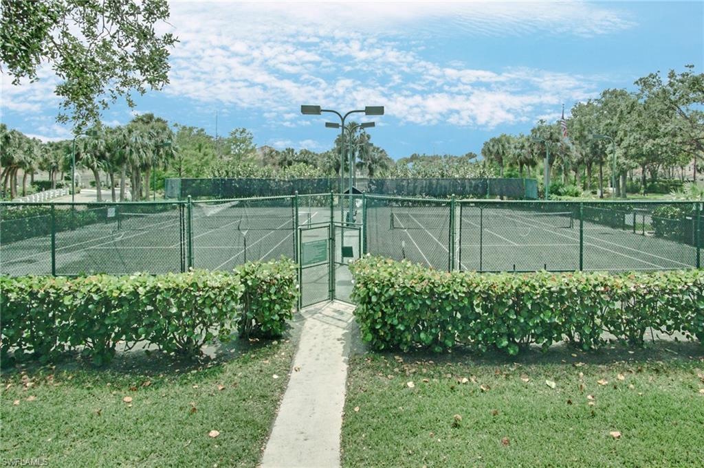 6910 Satinleaf Road North, Unit 204 Naples, FL 34109 - Photo 31 of 31 View of tennis court featuring fence